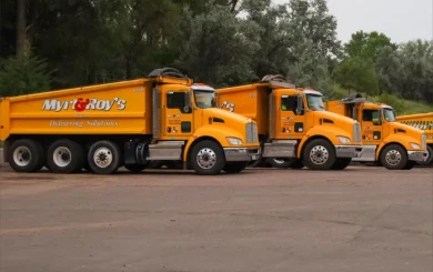 row of parked dump trucks
