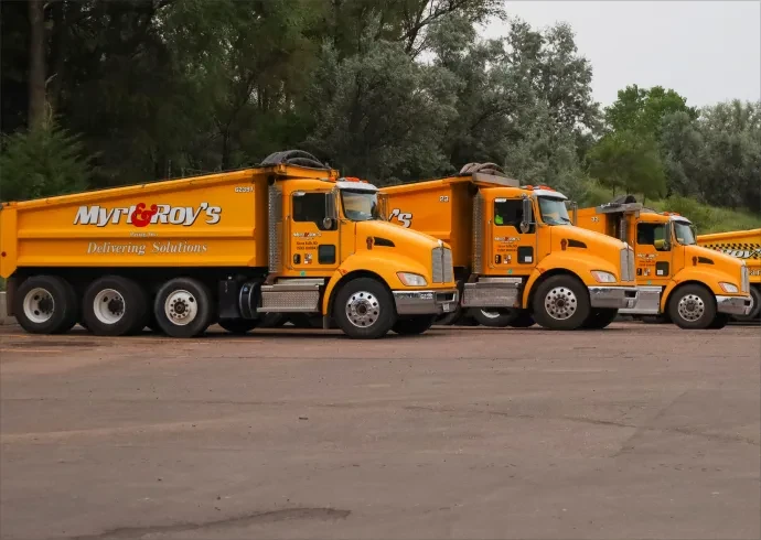 row of parked dump trucks