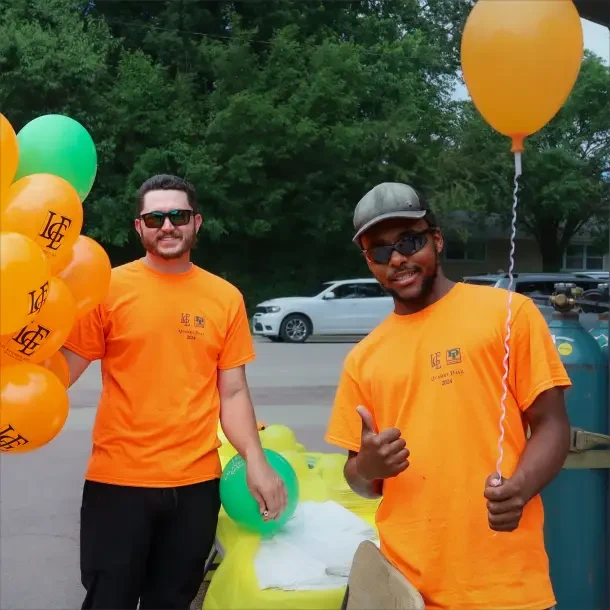 two men holding balloons at LG Everist career event